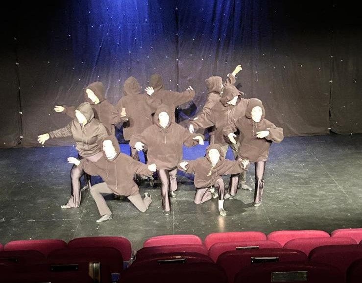Cheer group smiling mid-routine at Clairemarie’s School of Dance